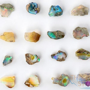 These raw Opal crystals are chunk shaped and rainbow colored with patches of tan matrix.
Crystals are nature-made therefore each one is unique in appearance.