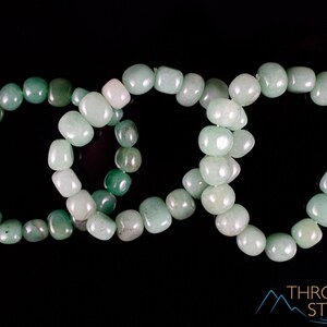 These pale Green Aventurine crystal bracelets have tumbled beads strung on elastic for an endless bracelet.  
Crystals are nature-made therefore each one is unique in appearance.