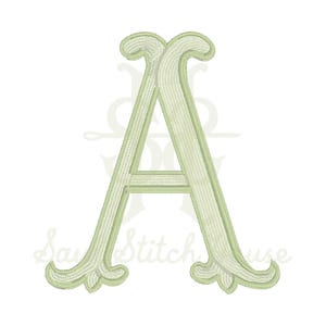 May include: A light sage green embroidered letter A featuring a decorative serif font with ornate, curled terminals at the base and top. The stitching pattern is visible throughout the letter, creating a textured appearance on the surface.