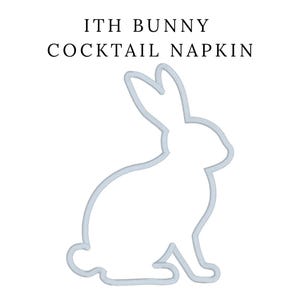 May include: White cocktail napkin with a light blue bunny outline. The text "ITH BUNNY COCKTAIL NAPKIN" is printed above the bunny outline. The bunny is in a seated position with its ears upright.