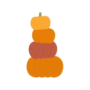 May include: A stack of four pumpkins in shades of orange and red, with a green stem on top. The pumpkins are arranged vertically, creating a fall-themed decorative element. The pumpkins have a textured, knitted appearance.