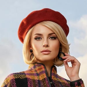 May include: A multi-colored plaid coat with a matching beret. The coat features a mix of orange, purple, and black squares, with black leather trim. The Eiffel Tower is visible in the background.