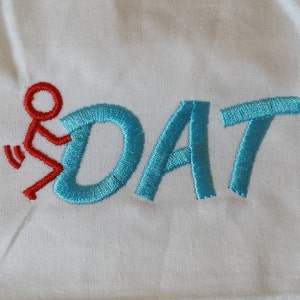 May include: Embroidered design of a stick figure in red, riding a blue "DAT" word.