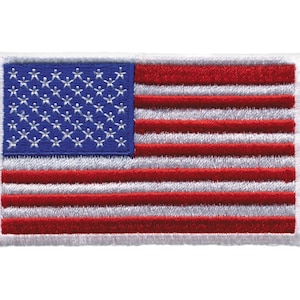 May include: An embroidered American flag patch with a white border. The flag is red, white, and blue with 13 red and white stripes and 50 white stars on a blue field.