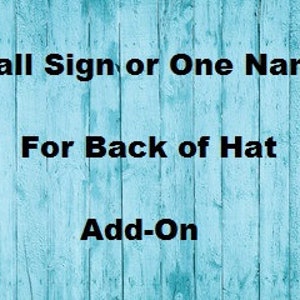 May include: A blue wooden background with black text that reads "Call Sign or One Name For Back of Hat Add-On".