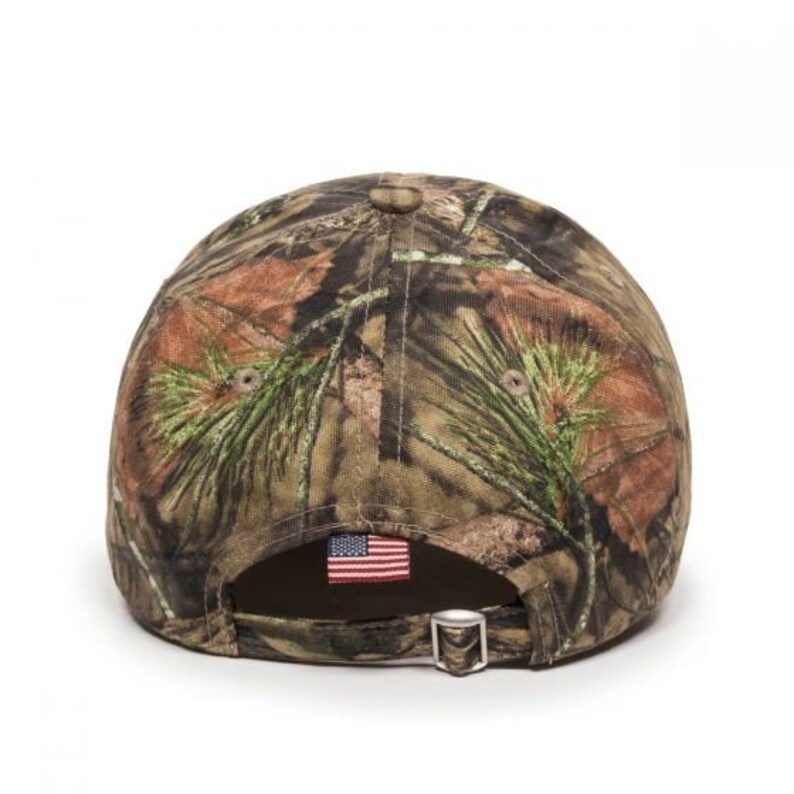 May include: A camouflage baseball cap with a small American flag patch on the back.