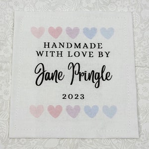 May include: White fabric label with pink and blue hearts, the text "HANDMADE WITH LOVE BY Jane Pringle 2023"