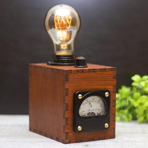 Wooden meter Edison lamp. Voltmeter lamp for electricians and engineers.