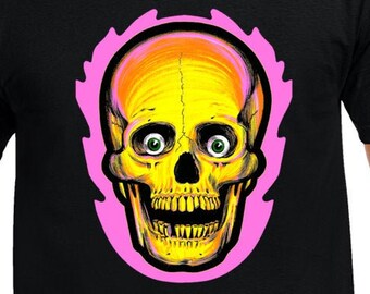 May include: Black t-shirt featuring a vibrant skull design. The skull is yellow and orange with green eyes, outlined in pink. The graphic is centered on the shirt, creating a bold statement.