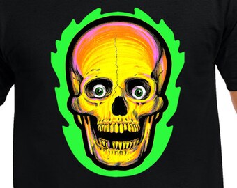 May include: Black t-shirt featuring a vibrant skull design. The skull is yellow and orange with green eyes, set against a green outline. A unique graphic tee for those who appreciate bold and edgy apparel.
