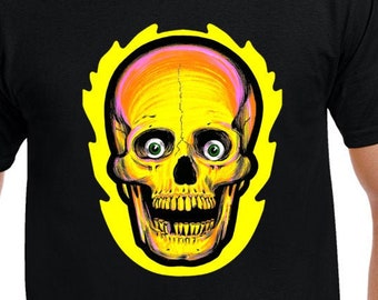 May include: Black t-shirt featuring a vibrant skull design. The skull is rendered in shades of yellow, orange, and pink, with green eyes, set against a yellow outline. The shirt is a classic crew neck style.
