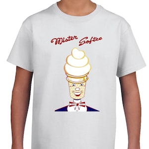 May include: White t-shirt featuring a cartoon ice cream cone character with a smiling face, bow tie, and the words "Mister Softee" in red script. The ice cream cone has a golden-yellow cone and a swirl of white ice cream.