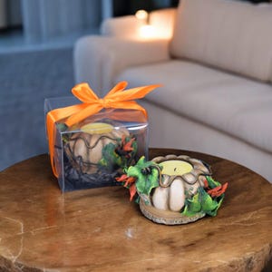 Beige handmade candle holder in the shape of a pumpkin with flowers and leaves. Halloween candle holder for tea candles in a gift box