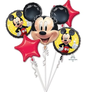May include: A balloon bouquet featuring a large Mickey Mouse head-shaped balloon, two round balloons with Mickey Mouse graphics on yellow backgrounds, and two red star-shaped balloons. Each balloon is attached to a white ribbon string.
