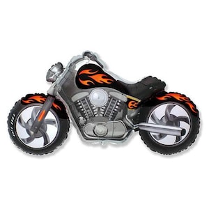 May include: A silver and black motorcycle-shaped balloon with orange flame accents. The balloon features detailed engine components, black tires, and a curved exhaust pipe. The design is suitable for a birthday or party.