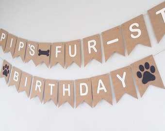May include: A banner with brown pennants strung on twine. The top banner reads "PIPS'S FUR-ST" with a bone graphic. The bottom banner says "BIRTHDAY" with a paw print graphic. White letters and graphics.