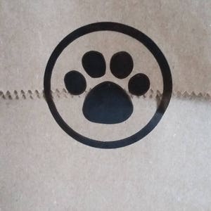 May include: A brown paper bag with a black paw print in a circle.