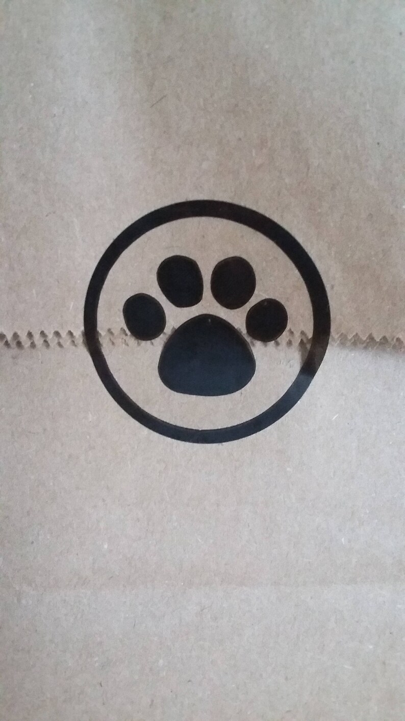 May include: A brown paper bag with a black paw print in a circle.