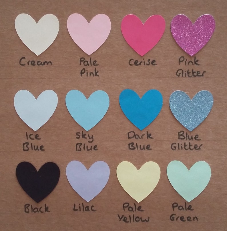 May include: A chart of 12 heart-shaped paper samples in various colors, including cream, pale pink, cerise, pink glitter, ice blue, sky blue, dark blue, blue glitter, black, lilac, pale yellow, and pale green. The colors are labeled below each heart.