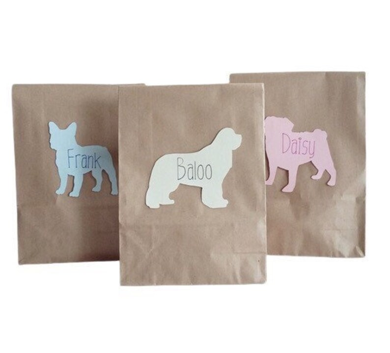 May include: Three brown paper bags with dog silhouettes and names. The bags are labeled "Frank", "Baloo", and "Daisy".