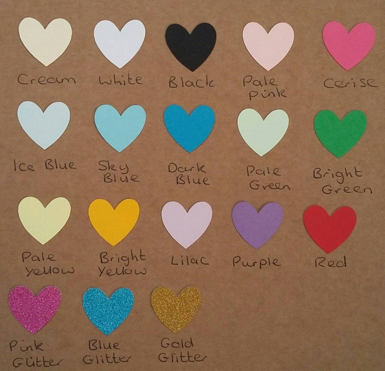 May include: A chart of 15 different colored heart shapes with the color name written below each heart. The colors include cream, white, black, pale pink, cerise, ice blue, sky blue, dark blue, pale green, bright green, pale yellow, bright yellow, lilac, purple, red, pink glitter, blue glitter, and gold glitter.