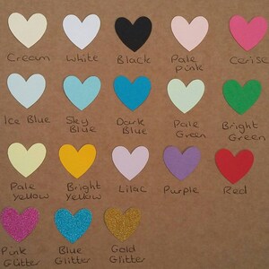 May include: A chart of 15 different colored heart shapes with the color name written below each heart. The colors include cream, white, black, pale pink, cerise, ice blue, sky blue, dark blue, pale green, bright green, pale yellow, bright yellow, lilac, purple, red, pink glitter, blue glitter, and gold glitter.