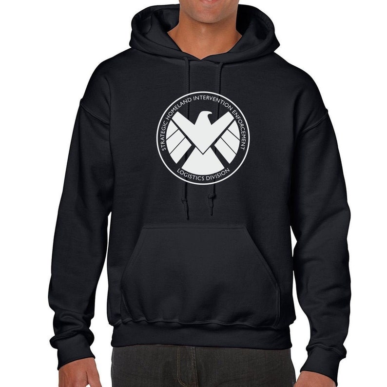 May include: Black hooded sweatshirt with a white logo of the S.H.I.E.L.D. logo. The logo features a white eagle with wings spread and the text "Strategic Homeland Intervention Enforcement Logistics Division".