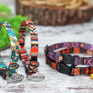 May include: Three colorful cat collars with adjustable buckles and breakaway safety clasps. The collars feature a geometric pattern in shades of orange, teal, purple, and black. Two of the collars have personalized name tags that read "KELLY I'm chipped" and "HAROLD". The third collar has a small bell attached.