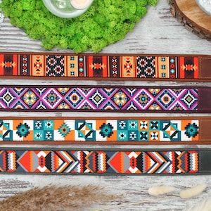 May include: Four colorful camera straps with geometric patterns. The straps are made of fabric and have a leather or suede backing. The patterns include orange, blue, green, purple, and white.