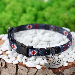 May include: A blue and red patterned cat collar with a black buckle and a silver tag that reads "MOLLY I'm chipped".