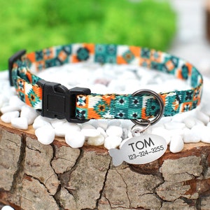May include: A colorful patterned dog collar with a black buckle and a silver fish-shaped tag that reads "TOM 123-324-3255".