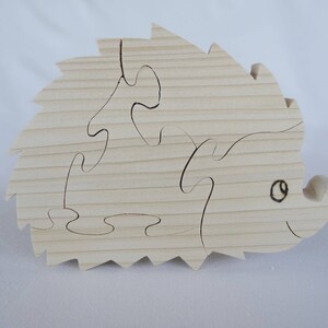 wooden puzzle "hedgehog" in natural spruce cut with a scroll saw