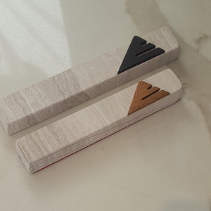 gray mezuzah case made of travertine