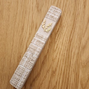 Kotel mezuzah case made from beige jerusalem type stone with sterling silver olive branch shin painted gold
