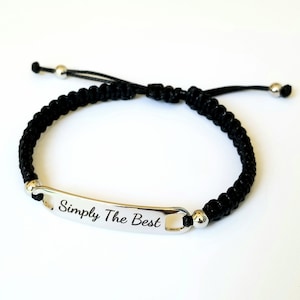 May include: Black braided bracelet with a silver tag that reads "Simply The Best".