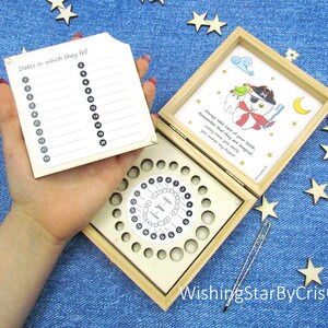 May include: Wooden box with a tooth fairy theme. The box has a compartment for storing baby teeth and a chart to record the dates they fell out. The box is decorated with a cartoon tooth fairy and the text "Always take care of your teeth, Remember that they are magical Every time you smile. you warm my heart!"