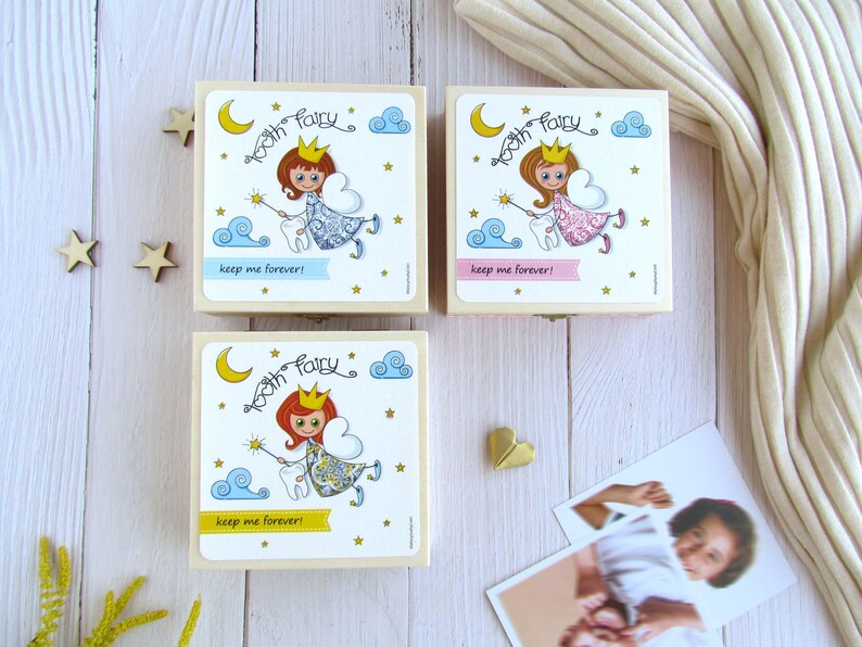 May include: Three wooden boxes with tooth fairy designs. Each box features a different colored fairy with a crown, wings, and a wand. The boxes have the text "Tooth Fairy" and "Keep me forever!" printed on them.