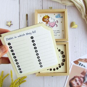 May include: A wooden box with a removable lid for storing baby teeth. The lid features a cartoon illustration of a tooth fairy with the text "If your teeth are magical, so is your smile, heart!" The box has a chart for recording the dates the teeth fell out.