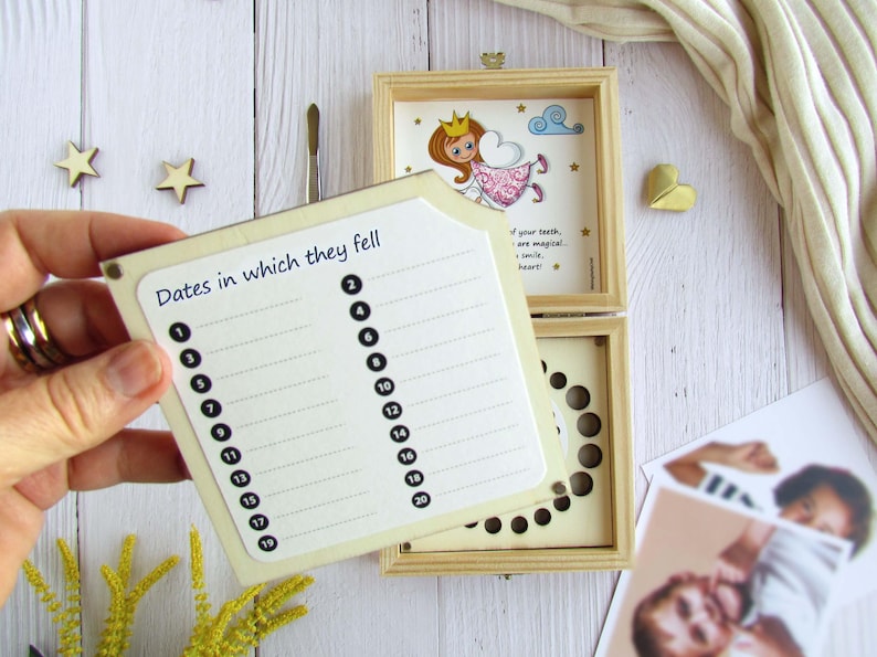 May include: A wooden box with a removable lid for storing baby teeth. The lid features a cartoon illustration of a tooth fairy with the text "If your teeth are magical, so is your smile, heart!" The box has a chart for recording the dates the teeth fell out.