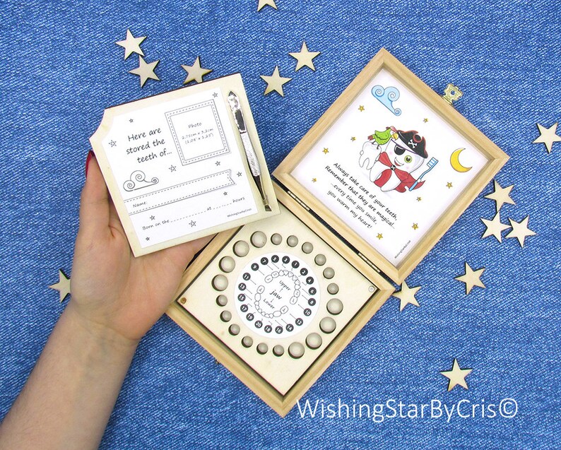 May include: Wooden box with a tooth fairy theme. The box has a compartment for storing baby teeth and a removable lid with a space for a photo and information about the child. The lid also has a quote about taking care of teeth. The box is decorated with stars and a moon.