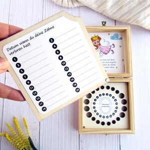 May include: A wooden box with a chart to track when a child loses their baby teeth. The chart has numbers 1 through 20. The box also has a compartment for storing lost teeth. The box has a fairy illustration with the text "When you lose a tooth, fairies are magic, they come to you at night, when you sleep, and take your tooth, and leave you a gift, my dear!"