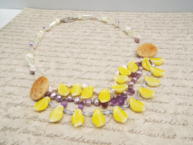 crystal and mother of pearl beads Amethyst crystal necklace with daffodil yellow petals yellow and purple necklace carved wooden buttons