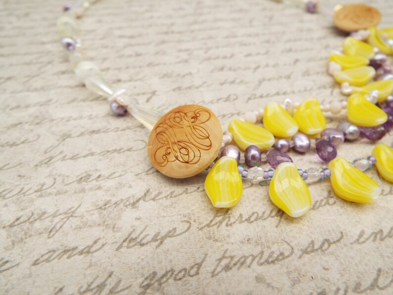 crystal and mother of pearl beads Amethyst crystal necklace with daffodil yellow petals yellow and purple necklace carved wooden buttons