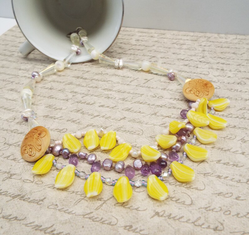 crystal and mother of pearl beads Amethyst crystal necklace with daffodil yellow petals yellow and purple necklace carved wooden buttons