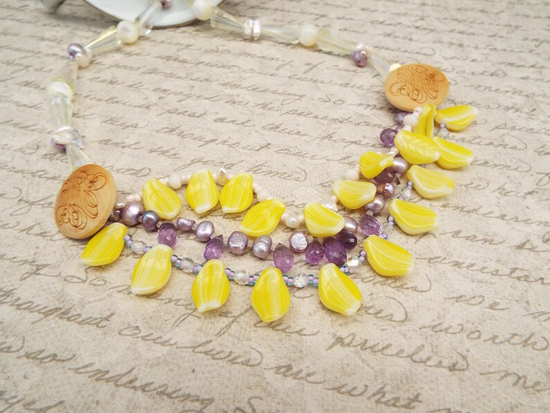 crystal and mother of pearl beads Amethyst crystal necklace with daffodil yellow petals yellow and purple necklace carved wooden buttons
