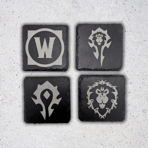 May include: Set of four black square coasters with different World of Warcraft logos in silver. The logos include the World of Warcraft logo, the Horde logo, the Alliance logo, and the Alliance lion logo.