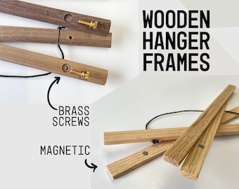 May include: Wooden hanger frames with brass screws and magnetic closures. The frames are made of natural wood and are designed to hang pictures or other artwork.