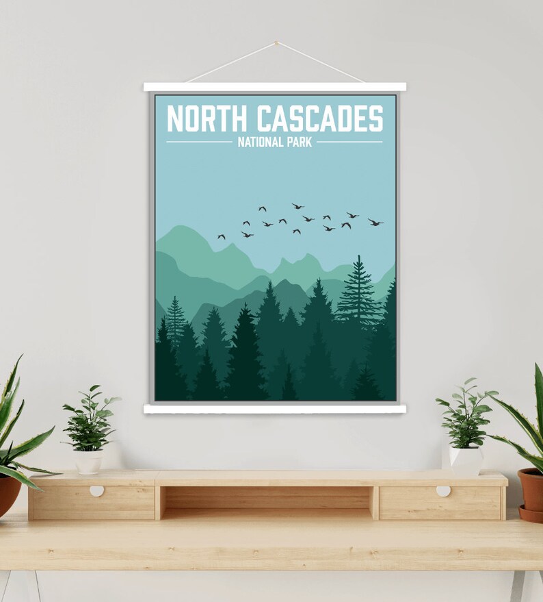 May include: A poster with a minimalist design featuring a silhouette of a forest with mountains in the background. The poster has the text "NORTH CASCADES NATIONAL PARK" at the top.