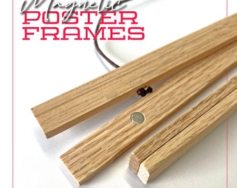 May include: Close-up of a set of three wooden magnetic poster frames. The frames are made of natural wood and have a simple, minimalist design. The frames are held together by magnets, which are visible in the image.