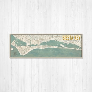 May include: A vintage-style map print of Siesta Key, Florida, with a teal and beige color scheme. The map shows the streets and waterways of the island. The text "SIESTA KEY Florida" is printed in gold at the top right corner.